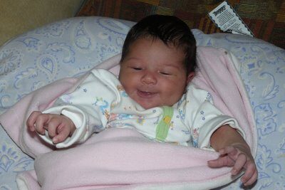At Almost 20 Days, Sofie Smiles by the Fire