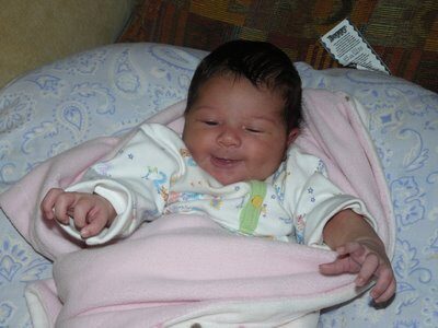 At Almost 20 Days, Sofie Smiles by the Fire