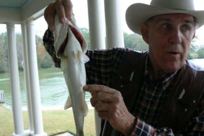 Ray Scott shows how to tell a male from a female bass. Just kidding.