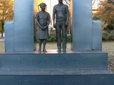 Statue in Kelly Ingram Park, Birmingham, with the inscription, 'We aint' afraid of your jail.'