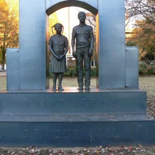 Statue in Kelly Ingram Park, Birmingham, with the inscription, 'We aint' afraid of your jail.'