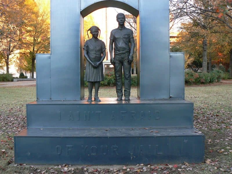 Statue in Kelly Ingram Park, Birmingham, with the inscription, 'We aint' afraid of your jail.'