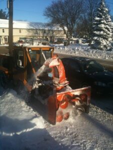 He Pilots a Giant Blue Mercury, or a Cool Orange Snowthrower