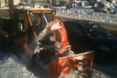 He Pilots a Giant Blue Mercury, or a Cool Orange Snowthrower