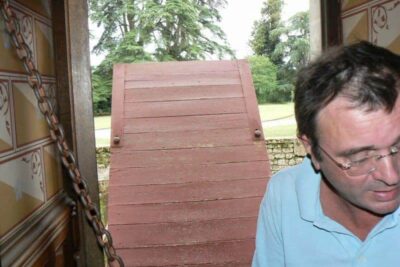 Sebastian shows us a room with a drawbridge at Chateau de Roquetaillade, in Mazieres, France.