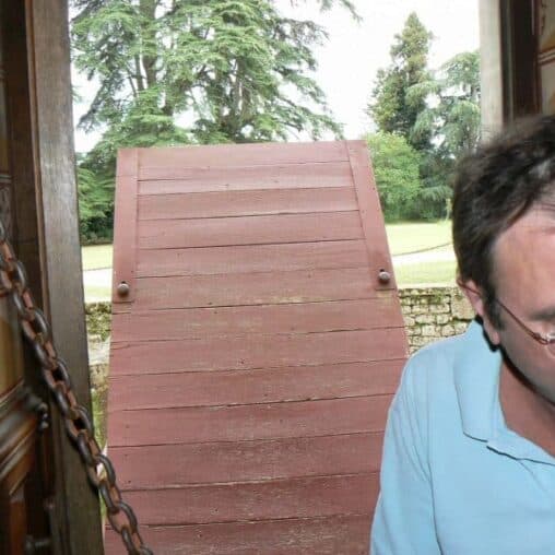 Sebastian shows us a room with a drawbridge at Chateau de Roquetaillade, in Mazieres, France.
