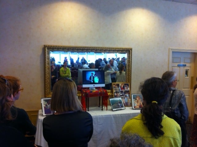 Friends viewing photos of Andrea Raphael at today's memorial service at the Log Cabin.