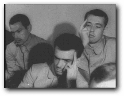 USS Pueblo crewmen showing their N. Korean captors the "Hawaiian Good Luck Sign."