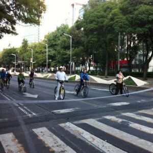 Mexico City bike riders wait for the light on the car-free Reforma boulevard.