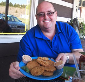 Tony Gore offers up his fried green tomatoes at his BBQ joint in Kodak, TN. 