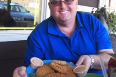 Tony Gore offers up his fried green tomatoes at his BBQ joint in Kodak, TN.