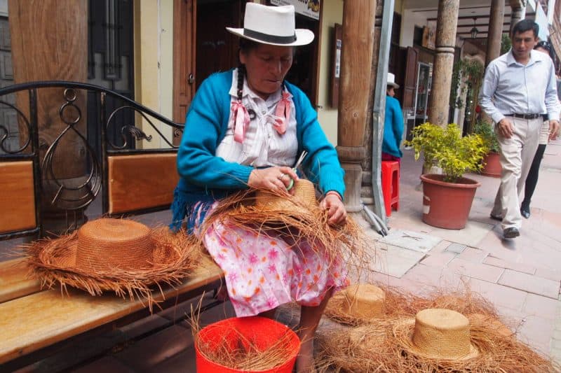 A native hatmaker creates straw hats in Ecuador.