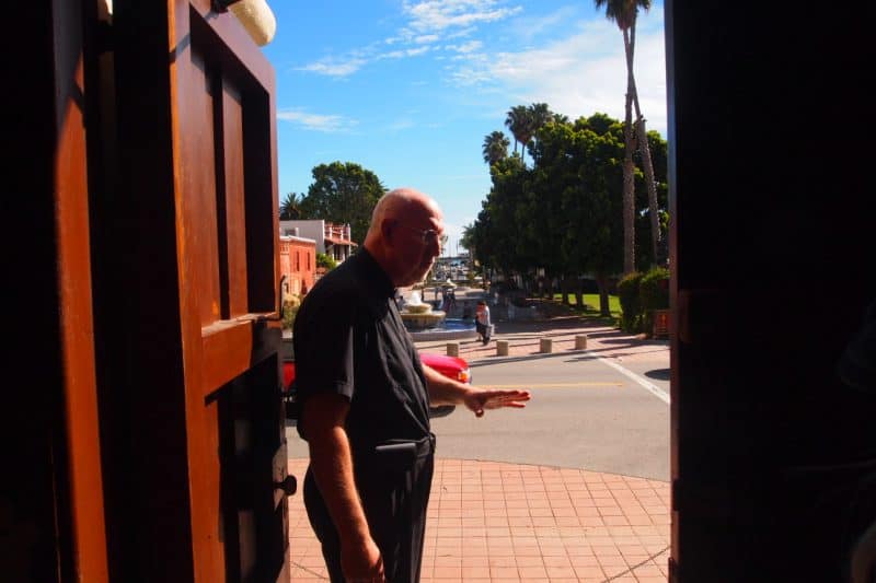 Father Tom Elewaut of the San Buenaventura Mission showing off his ocean view.