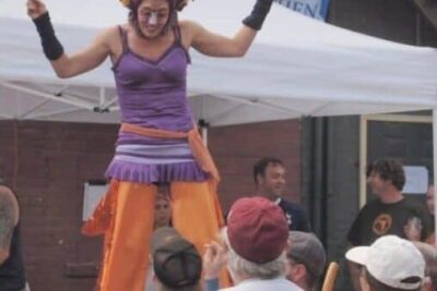 The Stilt lady, who told us she was 10 years old, entertains at the Brass Cat.