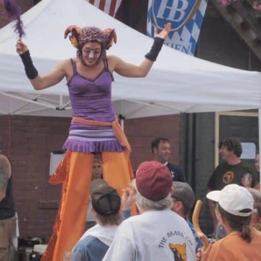 The Stilt lady, who told us she was 10 years old, entertains at the Brass Cat.