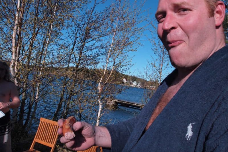 A proper Finnish sauna experience: grilled sausages, no buns, beer, and a birch log fire heated wood sauna. 
