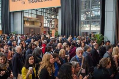 There's always a big line of travelers waiting to walk the aisles and see the attractions at the travel show.