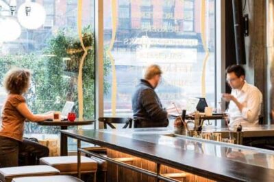 Inside the restaurant DBGB in New York City, workers enjoy the space while the restaurant is closed, and they pay to use it. 