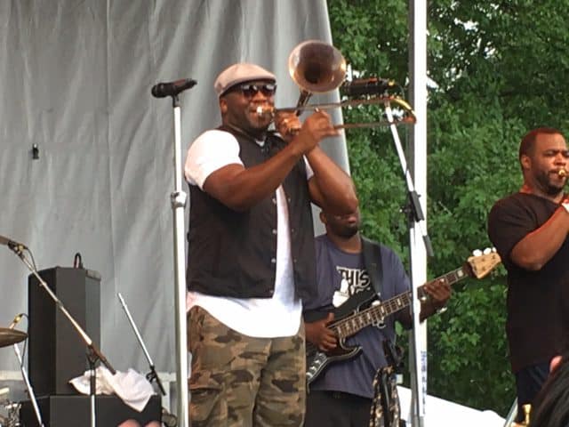 Big Sam Williams leads his band, Big Sam's Funky Nation in a groove-filled crazy dancing set in the pouring rain at the Four Rivers Stage on Sunday.