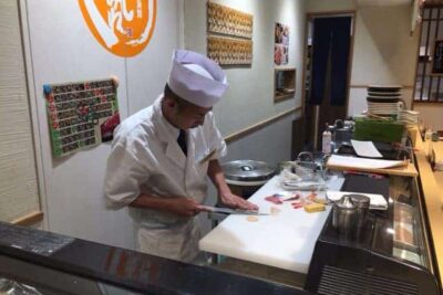 The sushi man about to create some tuna and eel rolls in Tokyo