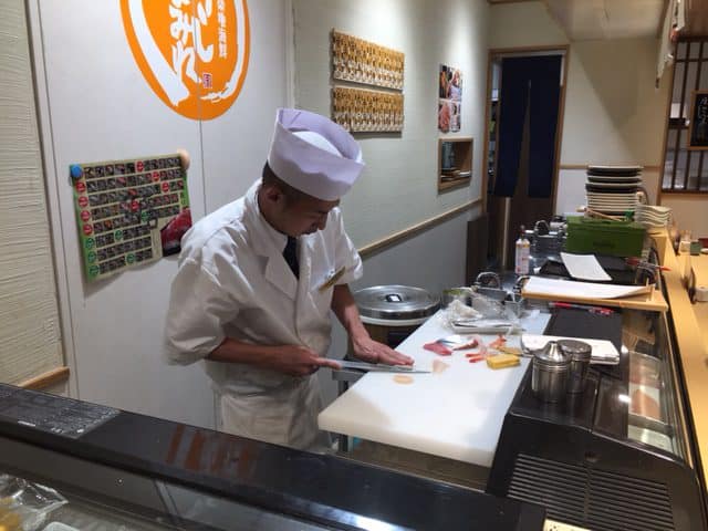 The sushi man about to create some tuna and eel rolls in Tokyo