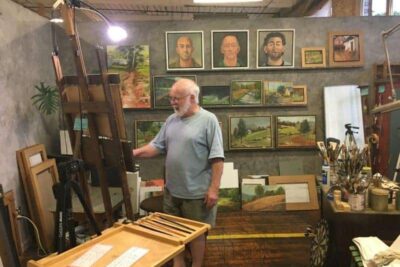 A painter working on oils at Lowe Mills.