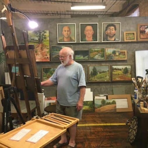 A painter working on oils at Lowe Mills.