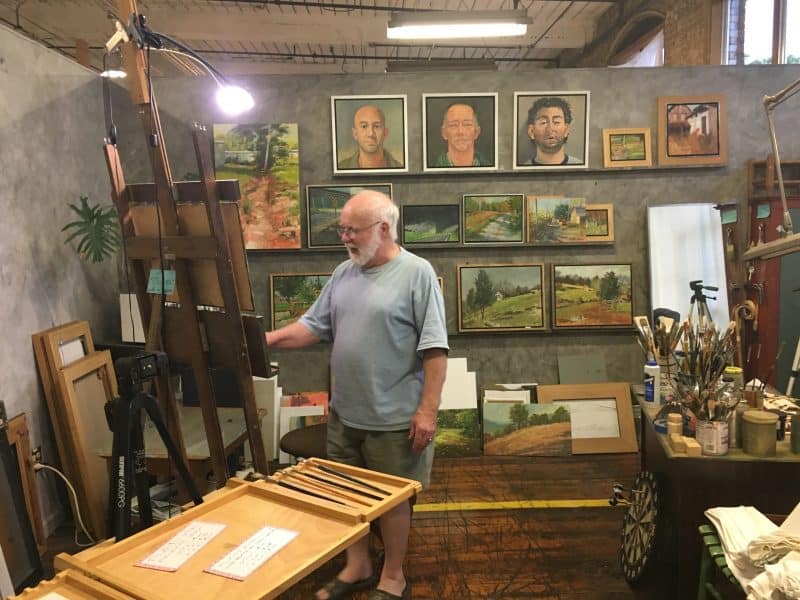 A painter working on oils at Lowe Mills.