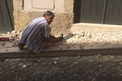 Low paid calceteiros are the men who create the works of art on Lisbon's sidewalks.
