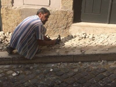 Low paid calceteiros are the men who create the works of art on Lisbon's sidewalks.