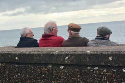 Local men enjoy some time in front of the English Channel in Sidmouth.
