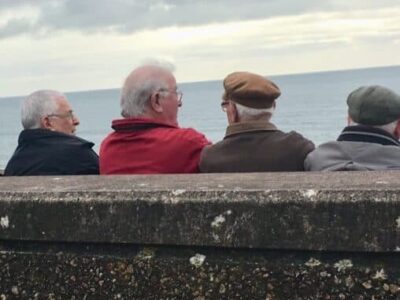 Local men enjoy some time in front of the English Channel in Sidmouth.