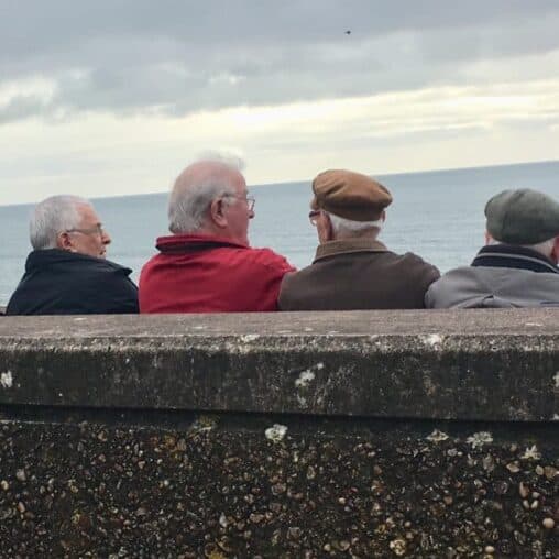 Local men enjoy some time in front of the English Channel in Sidmouth.