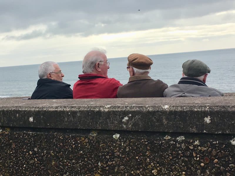 Local men enjoy some time in front of the English Channel in Sidmouth.