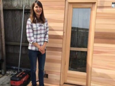 Julie Cox shows off what will soon be their new sauna at her surfer's gathering place in Pacifica called Traveler.