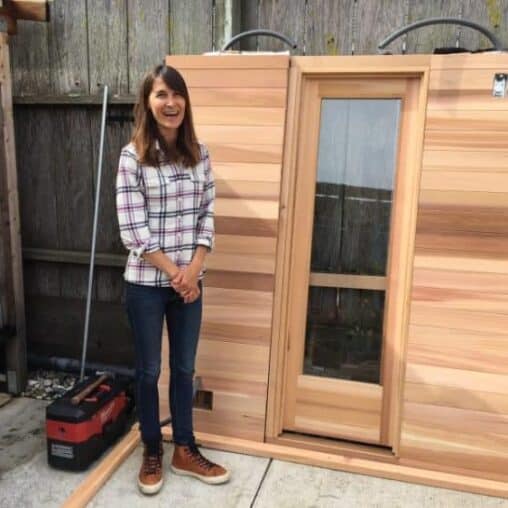 Julie Cox shows off what will soon be their new sauna at her surfer's gathering place in Pacifica called Traveler.
