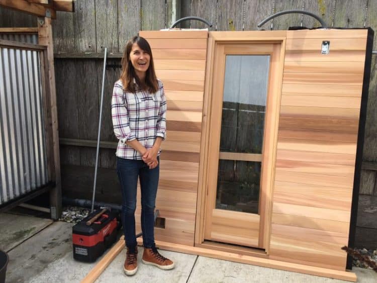 Julie Cox shows off what will soon be their new sauna at her surfer's gathering place in Pacifica called Traveler.