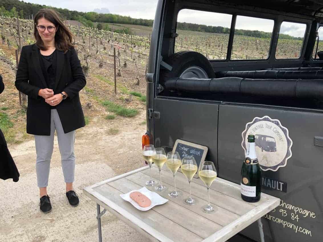 Maeva Garza of My Vintage Tour Company stands ready to pour in the vineyards of Champagne with her trusty Renault van. 