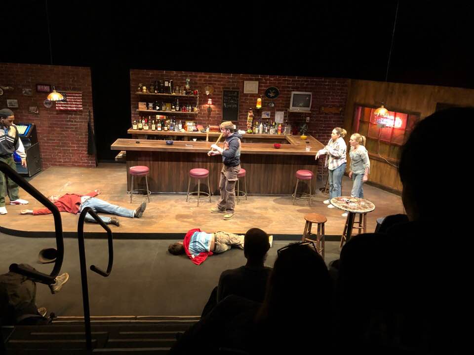Chris, (Isiah Michael Grace) looks at injured bartender Stan, (Ethan Blake) and Oscar, (Gabriel CiFuentes) on the floor as Jason (Jason Beckett) holds the bat used in the fight. Tracey (Jacqui Dupre) and Jessie (Rachel Hall) at right.