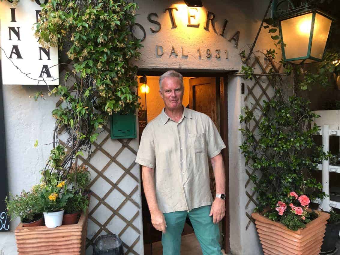 John Henderson, travel writer, in front of his favorite Osteria in Rome, his adopted hometown. 