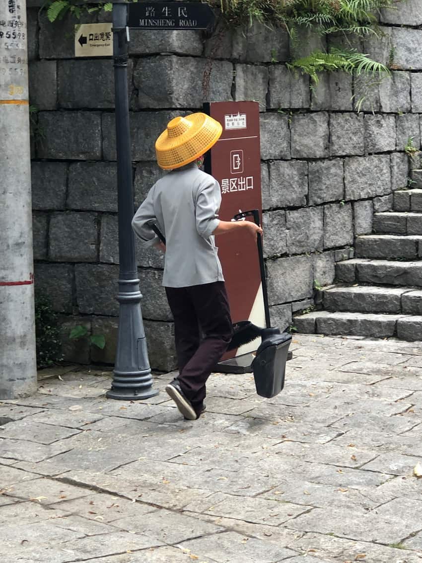 Sweepers are everywhere, usually in these hats with scarves covering their mouths.