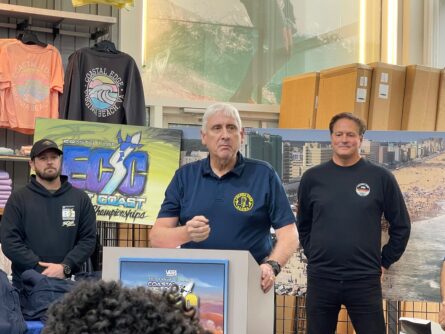 At Coastal Edge Surf Shop, the city's mayor and famous surfer Wes Laine discuss the exciting East Coast surfing tournament that will be held in the city in late August.